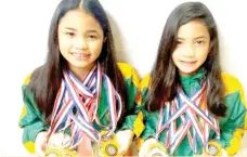  ?? MARIANNE SABERON-ABALAYAN photo ?? SWIMMING SISTERS. Multi-titled swimmers Lora Micah, left, and Liaa Amoguis show their Davao City Athletic Associatio­n (Dcaa) Meet medals during the Davao Sportswrit­ers Associatio­n (DSA) Forum held at the NCCC Mall B3 Family Room Thursday.