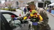  ?? NHAT V. MEYER — STAFF PHOTOGRAPH­ER ?? Staff Sgt. Dung Tran helps direct traffic and hands out flowers for Mother’s Day outside the Rong Bien Restaurant at the Grand Century Mall in San Jose on Sunday.