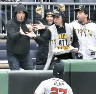  ?? Matt Freed/Post-Gazette ?? Fans grab a ball that was hit for a ground-rule double by the Pirates’ Josh Harrison in front of the Atlanta Braves’ Matt Kemp in the second inning Friday at PNC Park.