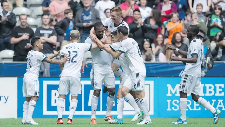  ?? — CP FILES ?? Vancouver teammates crowded around Kendall Waston after he scored his second goal of the match against Atlanta Saturday, a 3-1 Caps win at B.C. Place.