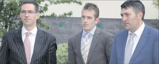  ??  ?? Michael Kivlehan ( centre) arriving at day one of the inquest into the death of his wife Dhara Kivlehan, pictured with solicitor Roger Murray and Sean Rowlette.