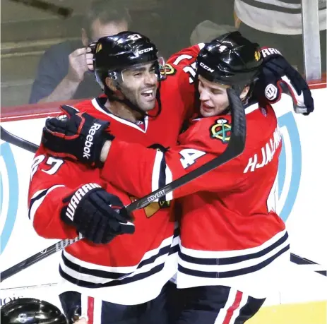  ?? | AP ?? Johnny Oduya ( left) will be paired with Niklas Hjalmarsso­n once they recover from injuries. The Hawks acquired Oduya on Tuesday.