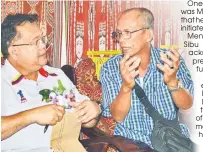  ??  ?? A longhouse resident having a chat with Nanta (left) during the programme.