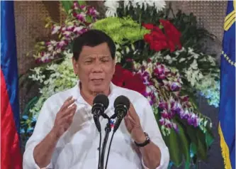  ??  ?? This photo taken on June 27, 2017 shows Philippine President Rodrigo Duterte giving a speech during Eid al-Fitr celebratio­ns at Malacanang Palace in Manila. — AFP