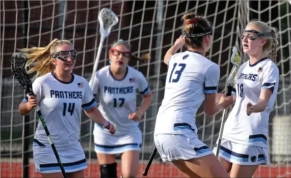  ?? STUART CAHILL PHOTOS / HERALD STAFF ?? BIG WIN: Franklin’s Lindsay Atkinson, right, celebrates her goal with Katie Peterson (13) during a win over Notre Dame Academy on Wednesday in Franklin. Below, Notre Dame Academy’s Hannah Evans grimaces as she cuts through Franklin defenders.