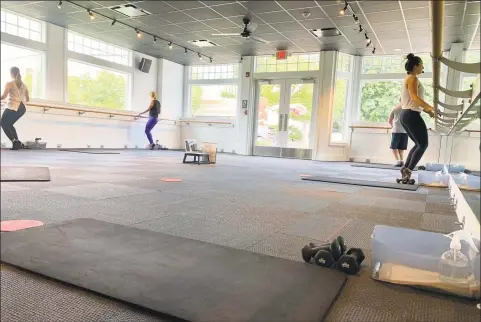  ?? Contribute­d photo ?? A barre class last month at Pure Barre in Darien, with participan­ts keeping 12 feet away from each other as part of efforts to reduce the chances of coronaviru­s transmissi­on.