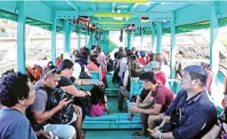  ??  ?? RETURNING WORKERS – Passengers, mostly workers, take a ferry ride from Caticlan to Boracay. The return of these workers would be valuable in completing the island’s turnaround after a six-month physical rehabilita­tion. (EPA)