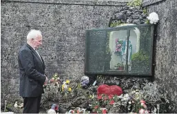  ?? CHARLES MCQUILLAN
GETTY IMAGES ?? Mother and Baby home survivor Walter Francis pays his respects at the shrine which stands on a mass burial site which was formerly part of the Bon Secours Mother and Baby home where, from 1921 to 1961, 978 children died.