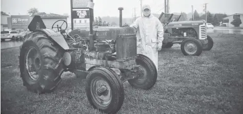  ?? [FAISAL ALI / THE OBSERVER] ?? Antiques straight off the farm from decades-past will be on display at the Wellesley Home Hardware. Organizing the tractor display and participat­ion in the noontime parade is Tim Leis, pictured with models dating back to the 1950s.