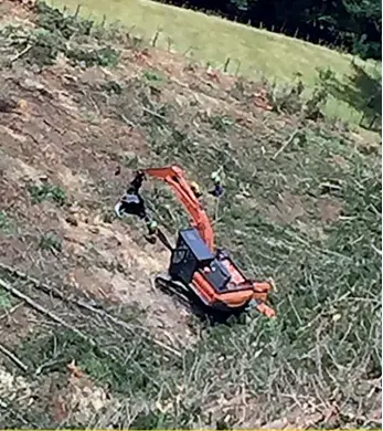  ??  ?? The Hitachi harvester at the bottom of the hill – the fire is out and the machine (and forest) was saved from destructio­n by Jack’s quick thinking and actions.