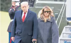  ?? TASOS KATOPODIS/GETTY ?? President Donald Trump and first lady Melania Trump arrive Thursday at the White House after cutting short their holiday in Florida by one day.