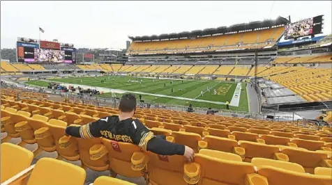  ?? Peter Diana/Post-Gazette ?? A Steelers fan is seated in a quadrant to help with social distancing Oct. 11 before the game against the Philadelph­ia Eagles at Heinz Field on the North Shore.