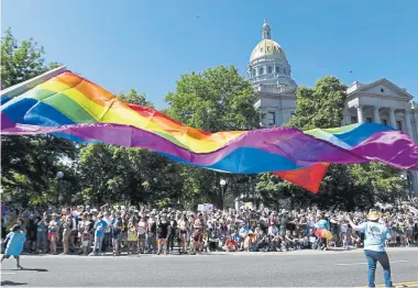  ?? Helen H. Richardson, The Denver Post ?? A Pride flag flies near the Colorado state Capitol along the Denver Pride Parade route on June 16, 2019. Since 1990, Denver Pridefest has grown into the largest celebratio­n of LGBTQ pride in the area. More than 250 groups marched in last year’s parade, a record for the event.