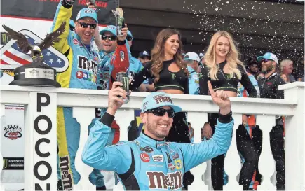  ?? MATTHEW O’HAREN/USA TODAY SPORTS ?? Kyle Busch celebrates in victory lane after winning the Pocono 400 on Sunday.