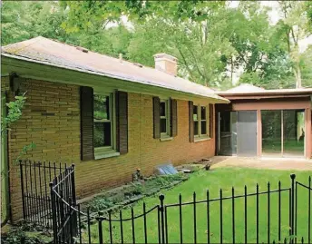  ??  ?? Sliding patio doors open off the remodeled kitchen into a Florida room that has panoramic views of the terraced back yard. A door opens from the Florida room to a paver brick patio. Another door opens off the Florida room into the garage, which has access to the finished, walk-out basement.