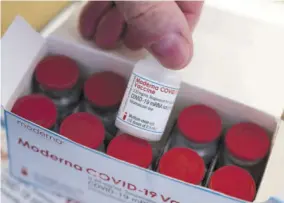  ?? (Photos: AP) ?? A man shows a vial of a COVID-19 vaccine from Moderna intended for the vaccinatio­n centre of the Klinikum in Stuttgart, Germany.