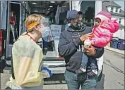  ?? Erin Clark Boston Globe ?? DR. RACHEL SAGOR greets Kyle Johnson, 1, and father Kahlid at a mobile clinic in Boston.