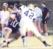  ?? Westside Eagle Observer/MIKE ECKELS ?? Bulldog Dayton Butler (42) takes down the Eagle quarterbac­k for a sack during the first two minutes of the third quarter of the Conway Christian-Decatur football contest in Conway Friday night. The Eagles were never able to recover the yards lost on this play, returning the ball to the Bulldogs.