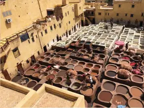  ??  ?? The strong smelling tanneries are viewed from the rooftops of buildings in the Fez medina