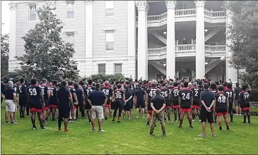  ?? CONTRIBUTE­D BY UNIVERSITY OF GEORGIA ?? Georgia Bulldogs football players gather Tuesday in front of the Holmes-Hunter Academic Building of UGA’s North Campus to hear Dr. Hamilton E. Holmes Jr. speak about racial equality.