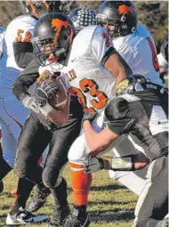  ?? | RANDY STUKENBERG/FOR SUN-TIMES MEDIA ?? Leo’s Marquis Williams slips through the arms of Lena-Winslow’s Matt Greene in the first half Saturday.