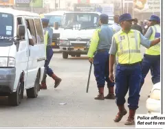  ?? ?? Police officers are working flat out to restore order