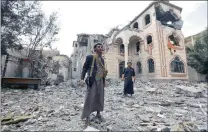  ?? Picture: EPA/YAHYA ?? FORGOTTEN: Armed Yemenis stand amid the ruins of the house of an army commander loyal to the Houthis after it was hit by two air strikes allegedly carried out by the Saudi-led coalition.