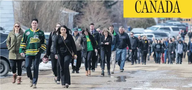  ?? LIAM RICHARDS / THE CANADIAN PRESS ?? Mourners head into a memorial service for Logan Schatz, captain of the Humboldt Broncos hockey team, in Allan, Sask.