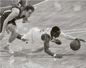  ?? Eric Gay / Associated Press ?? Matt Coleman III, right, and Texas were edged by guard Mac McClung and Texas Tech on Wednesday, the Longhorns’ first loss in league play.