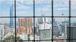  ?? ?? Dig deep: Commercial and residentia­l buildings in the heart of Kuala Lumpur. Tomorrow the national budget will be announced and it comes amid a call for tax investigat­ions to be stepped up. — Bloomberg