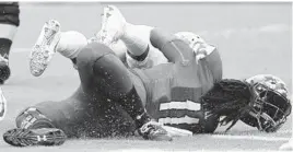  ?? ROB CARR/GETTY IMAGES ?? Maryland quarterbac­k Kasim Hill is hit early in the second quarter Saturday in Landover by Texas’ Gary Johnson, who is called for targeting and ejected from the game.