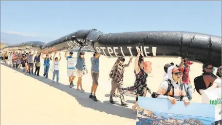  ?? Christina House For The Times ?? PEOPLE RALLY near the Santa Barbara County oil spill site. Lawmakers also want to bar drilling in environmen­tally sensitive areas.