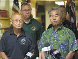  ?? GEORGE F. LEE — THE STAR-ADVERTISER VIA AP ?? Vern Miyagi, Administra­tor, HEMA, left, and Hawaii Gov. David Ige addressed the media Saturday, saying the false ballistic missile alarm was due to human error.