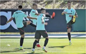  ??  ?? Portugal forward Cristiano Ronaldo (right) and teammates attend a training session at the Cidade do Futebol training camp in Oeiras, outside Lisbon, yesterday, ahead of their 2022 World Cup European Group A qualifier against Ireland. — AFP