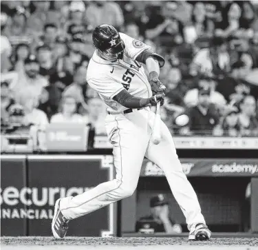  ?? Karen Warren / Staff photograph­er ?? Taylor Jones hits a triple during the sixth inning against the Mariners on Saturday. While playing a position he doesn’t typically, left field, Jones produced a stellar day at the plate and also doubled and homered.