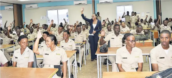  ??  ?? Sashelle Gooden (centre), senior communicat­ion specialist at the Jamaica Productivi­ty Centre, has a light moment with cadets of the Caribbean Maritime University during the pep talk session on transferri­ng their good principles to their peers in the...