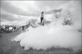  ?? AP/The Berkshire Eagle/STEPHANIE ZOLLSHAN ?? Harry Park of the Berkshire Museum in Pittsfield, Mass., creates a “thunder cloud” by pouring boiling water into a bucket of liquid nitrogen as part of March for Science festivitie­s in Pittsfield.