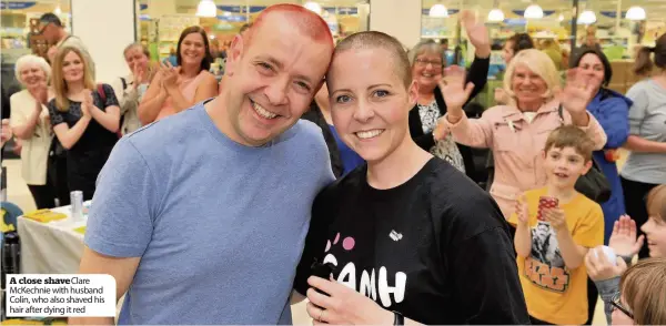  ??  ?? A close shave Clare McKechnie with husband Colin, who also shaved his hair after dying it red