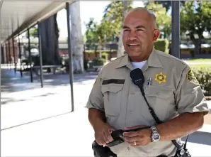  ?? Katharine Lotze/The Signal ?? School Resource Officer Javier Guzman talks with students at Hart High School on Aug. 28.