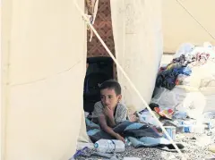  ?? REUTERS ?? A boy who is a relative of men accused of being Islamic State militants sits in a tent at a camp in Bartella, east of Mosul, Iraq, on Saturday.