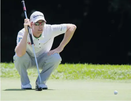  ?? AARON LYNETT/THE CANADIAN PRESS ?? Canada’s David Hearn, shown lining up a putt on the 13th hole during the final round of the 2013 RBC Canadian Open last month at Glen Abbey Golf Club in Oakville, Ont., likes his chances in the PGA Championsh­ip at the Oak Hill Country Club in...