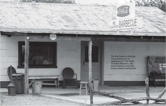  ??  ?? The Gas Station in Bastrop, Texas, famous for its appearance in ‘The Texas Chainsaw Massacre,’ also serves barbecue and sells horror-related merchandis­e.