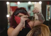  ?? RICH PEDRONCELL­I — THE ASSOCIATED PRESS ?? Amy Johnson, the owner of Rockabetty’s Hair Parlor, does a hair tinting for client Diane Reimanis in Yuba City on Monday.