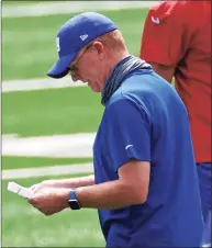  ?? Adam Hunger / Associated Press ?? New York Giants offensive coordinato­r Jason Garrett calls out a play during a practice at the NFL team’s training camp in East Rutherford, N.J. Garrett will be back on the sideline after missing last week’s game due to COVID-19.