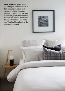  ??  ?? BEDROOMS Soft greys, black and white give a cohesive look to the bedrooms where art and statement lighting share the spotlight. Stuart bought the print of the little girl for about $10 in a Beijing street market. The blinds throughout the home are made from Textilia’s Pietro fabric in the colourway stone wall.