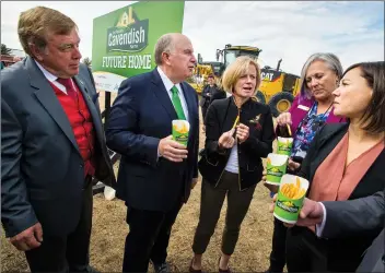  ?? HERALD PHOTO IAN MARTENS ?? Mayor Chris Spearman stands next to Cavendish Farms president Robert Irving, Premier Rachel Notley and Lethbridge MLAs Maria Fitzpatric­k and Shannon Phillips as they share a snack of french fries following the official groundbrea­king ceremony Monday...