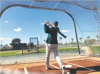  ?? Susan Slusser / The Chronicle ?? A's third baseman Matt Chapman takes batting practice for the first time since his offseason thumb and shoulder surgeries. “The ball was coming off my bat like I expected it,” he said.