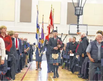  ?? LAWRENCE POWELL PHOTOS ?? The colour party parades in at the beginning of the Remembranc­e Day Ceremony in Bridgetown Nov. 11. It was the first time it was held in the Bridgetown Regional Community School and the gymnasium was packed.