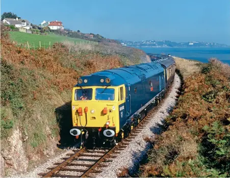  ??  ?? RIGHT: Although it has now been out of use for well over 20 years, 50002 Superb will always have a place in Class 50 preservati­on history for being the first preserved Class 50 to haul a passenger train in April 1992. On October 16, 1993, 50002 rounds the curve at Broadsands during a special Class 50 weekend. The Devon Diesel Society is now working on returning 50002 to service. Martin Loader