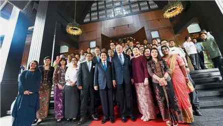  ?? — Bernama ?? One for the album: Najib posing for a photograph with Tan Sri Onn Mahmud (on Najib’s right), the chairman of AJ Resorts Sdn Bhd and owner of Ritz- Carlton Langkawi, and hotel staff at the official opening of Ritz- Carlton Langkawi.